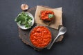 Tasty ajvar on toast. Vegetable sauce of baked red bell pepper on black. Balkan cuisine Royalty Free Stock Photo