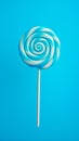 Tasty appetising party accessory sweet swirl candy lollypop on blue background top view. Generative AI