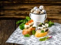 Tasty appetizer of quail eggs with red and black caviar.