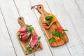 Tasty appetizer of thinly sliced spicy salami on bread with cheese and herbs and Italian bruschetta with fresh tomatoes Royalty Free Stock Photo