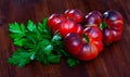 Tasty appetizing blue tomatoes on wooden surface