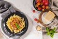 Tasty appetizing classic italian penne pasta with vegetarian lentil bolognese sauce, cheese parmesan and basil on plate on light Royalty Free Stock Photo