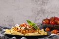 Tasty appetizing classic italian penne pasta with vegetarian lentil bolognese sauce, cheese parmesan and basil on plate on light Royalty Free Stock Photo