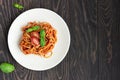 Tasty appetizing classic italian spaghetti pasta with tomato sauce, fresh cherry tomatoes and basil on ceramic plate. Royalty Free Stock Photo