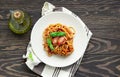 Tasty appetizing classic italian spaghetti pasta with tomato sauce, fresh cherry tomatoes and basil on ceramic plate. Royalty Free Stock Photo