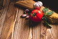 Tasty appetizing italian spaghetti pasta ingredients for kitchen cuisine with tomato, garlic and basil on wooden brown table. Food Royalty Free Stock Photo