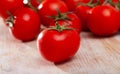 Tasty appetizing tomatoes on a wooden surface