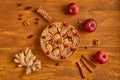 Tasty apple pie with fresh red cranberries and walnuts decorated with three apples, ginger, cinnamon. Just backed apple pie Royalty Free Stock Photo
