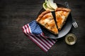 Tasty apple pie with national flag of USA on wooden background Royalty Free Stock Photo