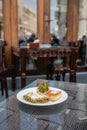 Tasty arabic sweet dessert with pistachios on white plate in typical local cafe in Doha City