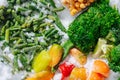 Tasty assortment of frozen berries, greens and veggies on grinded ice. top view. Royalty Free Stock Photo