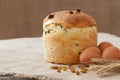 Tasty backed traditional russian kulich easter cake with raisins and eggs on vintage textile Royalty Free Stock Photo