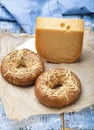 Tasty baked bagels with melted cheese and piece of aged Dutch Gouda cheese