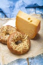 Tasty baked bagels with melted cheese and piece of aged Dutch Gouda cheese