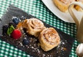 Tasty baked cinnabon rolls served with powdered sugar and berries Royalty Free Stock Photo