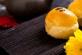 Tasty baked egg yolk pastry moon cake for Mid-Autumn Festival on black slate dark background. Chinese festive food concept, close Royalty Free Stock Photo