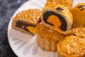 Tasty baked egg yolk pastry moon cake for Mid-Autumn Festival on black slate dark background. Chinese festive food concept, close Royalty Free Stock Photo