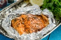 Tasty Baked Fish Salmon in Foil on Blue Table, Top View Royalty Free Stock Photo