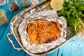 Tasty Baked Fish Salmon in Foil on Blue Table, Top View Royalty Free Stock Photo