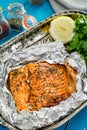 Tasty Baked Fish Salmon in Foil on Blue Table, Top View Royalty Free Stock Photo