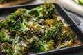 Tasty baked kale chips with cheese on table