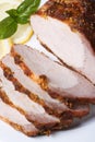 Tasty baked pork fillet and basil on a plate. vertical close up Royalty Free Stock Photo