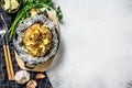 Tasty baked potato topped with cheddar cheese and chives. White background. Top view. Copy space