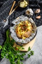 Tasty baked potato topped with cheddar cheese and chives. White background. Top view