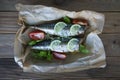 Tasty baked whole sea fishes on baking paper. Baked sea bream with lemon, herbs, tomatoes, spices on woode rustic background. Gril Royalty Free Stock Photo