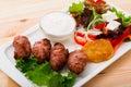 Tasty  balkan minced meat kebapcheta served with onion,  tomatoes, lettuce Royalty Free Stock Photo