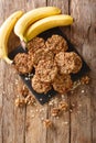 Tasty banana cookies with oatmeal and walnuts close-up on a slate board. Vertical top view Royalty Free Stock Photo