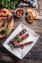 Tasty barbecue grilled pork ribs with chili pepers and parsley h