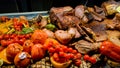 Tasty barbecue steak with tomato, chili and onions on the grill pan close-up on the table Royalty Free Stock Photo