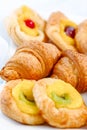 Tasty and beautiful croissants with jam, various forms of close up laid out on a white dish