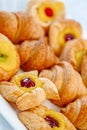 Tasty and beautiful croissants with jam, various forms of close up laid out on a white dish