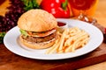 Tasty beef burger and french fries on white plate Royalty Free Stock Photo