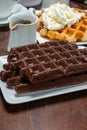 Tasty Belgian dessert, Brussels waffles with chocolade and whipped cream Royalty Free Stock Photo