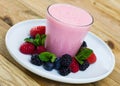 Tasty berry milk smoothie closeup