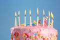 Tasty birthday cake with burning candles on color background, closeup Royalty Free Stock Photo