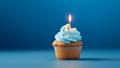 Tasty birthday cupcake with a candle on a blue background. Mini cake. Ai generative