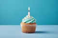 Tasty birthday cupcake with a candle on a blue background. Mini cake. Ai generative