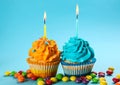 Tasty birthday cupcakes with burning candles on color background Royalty Free Stock Photo