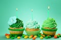 Tasty birthday cupcakes with burning candles on color background Royalty Free Stock Photo
