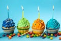 Tasty birthday cupcakes with burning candles on color background Royalty Free Stock Photo