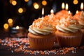 Tasty birthday cupcakes with candles on table