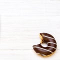 Tasty bitten donuts with icing and chocolate