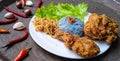 Tasty blue rice with fried chiken, noodle and green letuce