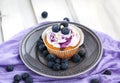 Tasty blueberry cupcake on plate