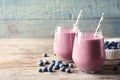 Tasty blueberry smoothie in glasses and berries