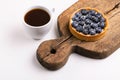 Tasty blueberry tart with vanilla cream and cup of coffee Royalty Free Stock Photo